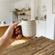 Ceramic coffee mug candle in kitchen