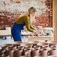 potter making candle pots